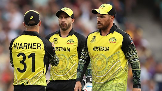 David Warner, Matthew Wade and Aaron Finch confer during the World Cup. 