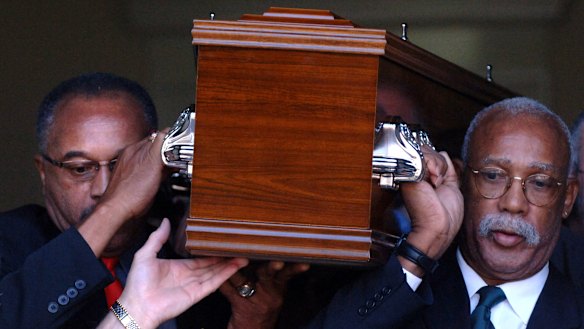 Respect: Tommie Smith (left) and John Carlos carry the coffin of Peter Norman from Williamstown Town Hall in Melbourne in 2006.