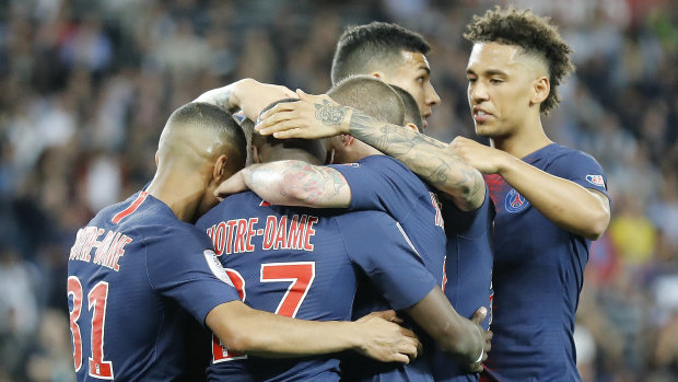 PSG players, with Notre Dame on the back of their jerseys, celebrate after Kylian Mbappe scored.