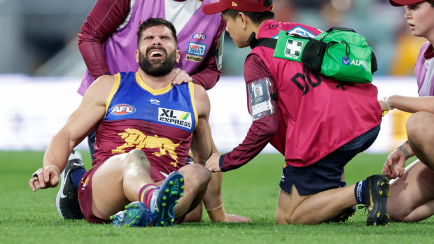 Marcus Adams pictured being assisted by trainers during round 21 last season.