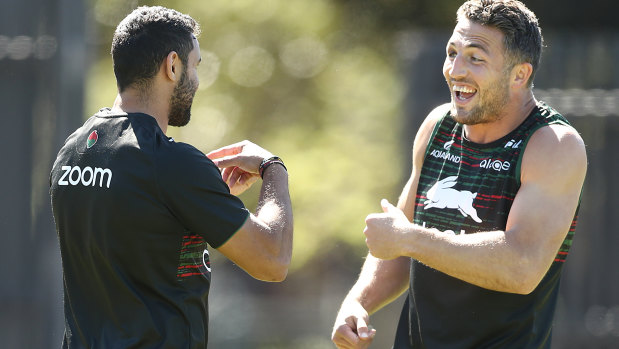 Sam Burgess shares a joke with Alex Johnston at Souths training on Tuesday.
