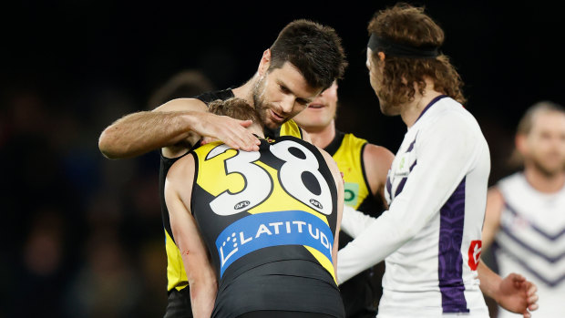 Noah Cumberland is consoled by former Richmond captain Trent Cotchin following the Tigers’ draw with the Dockers.