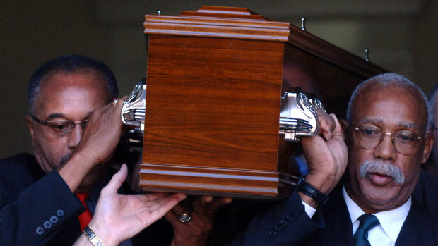 Respect: Tommie Smith (left) and John Carlos carry the coffin of Peter Norman from Williamstown Town Hall in Melbourne in 2006.