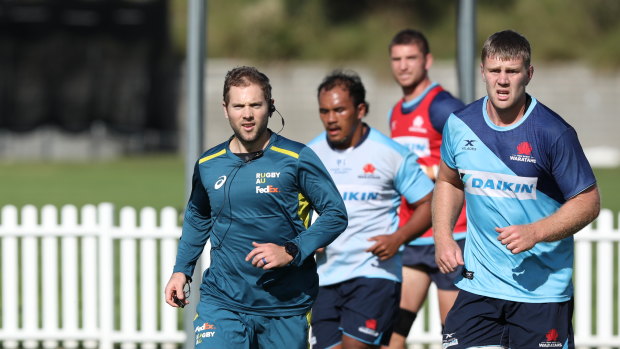 Referee Angus Gardner with Waratahs players as they train at David Phillips Sports Field on Friday. 