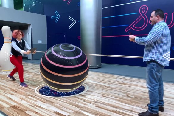 Playing a weird competitive bowling game that showed off Apple's latest AR tech.