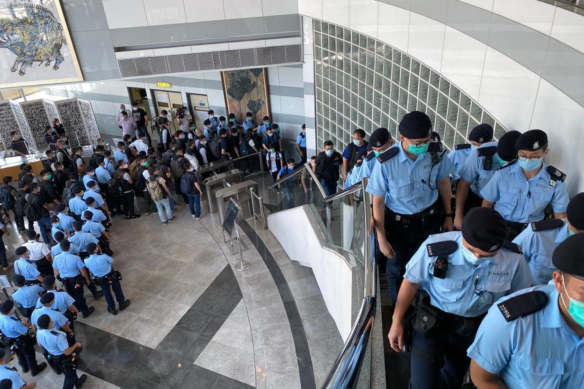Hong Kong police raid the Apple Daily headquarters on Monday.