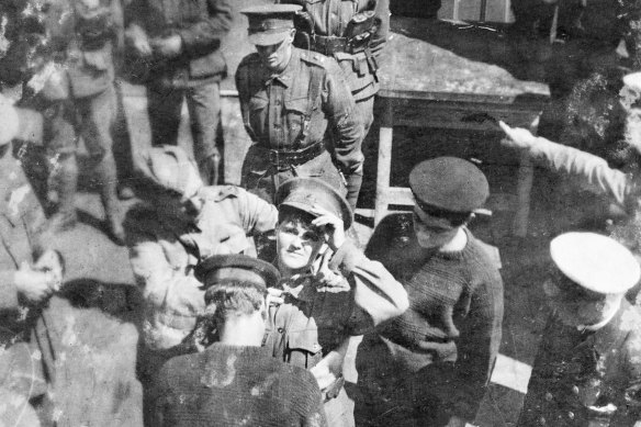 Maud Butler being fitted with a life belt before being transferred at sea from HMAT Suevic to the Blue Funnel liner Achilles on December 24, 1915. 
