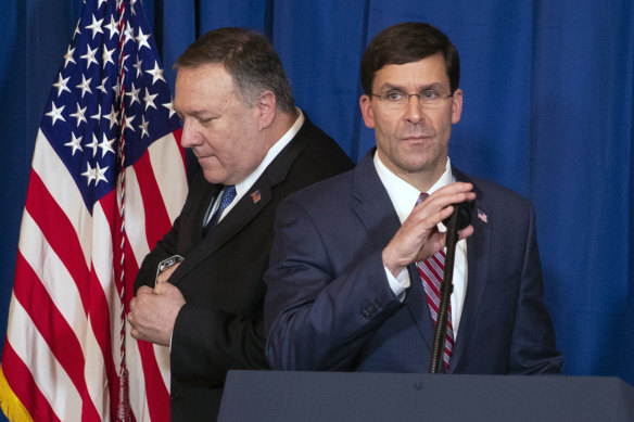 Secretary of State Mike Pompeo (left) hands the microphone to Secretary of Defence Mark Esper to deliver a statement on Iraq and Syria at President Donald Trump's Mar-a-Lago property.