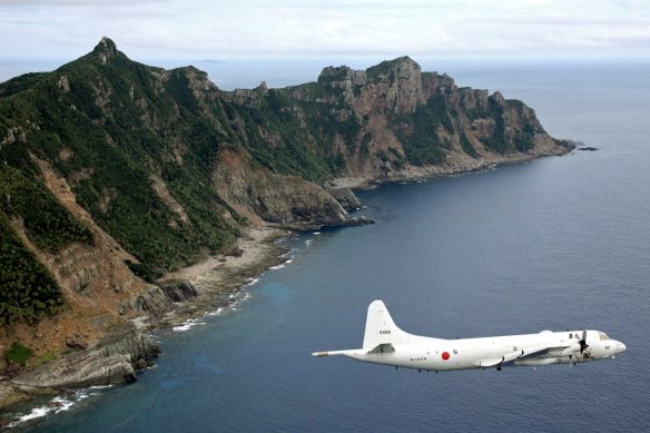 A Japan surveillance plane flies over the disputed islands, called the Senkaku in Japan and Diaoyu in China, in the East China Sea. 