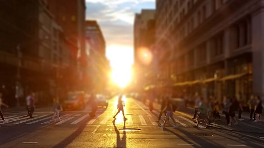 Woman walks across an intersection on 5th Avenue in Manhattan New York City.