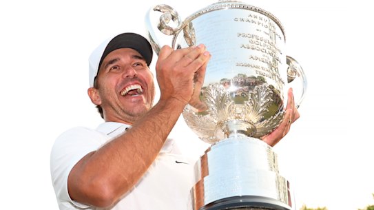 Brooks Koepka holds up the Wanamaker Trophy after winning the 2023 PGA Championship.