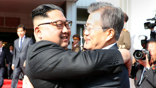 North Korean leader Kim Jong-un embraces South Korea's President Moon Jae-in after their summit in the Demilitarised Zone on May 26.