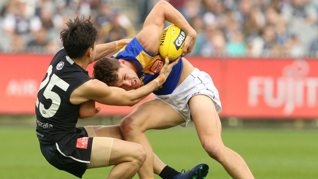 Fighting spirit: Zac Fisher brings down West Coast's Jack Redden.