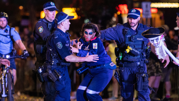 Police remove a protester fromthe parade route.