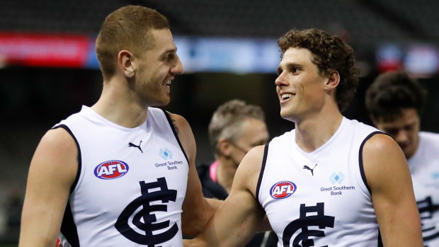 Liam Jones and Charlie Curnow walk off the ground victorious after their win over the Saints.