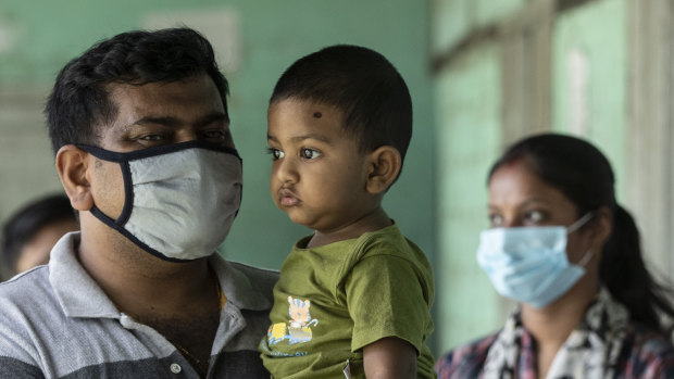 People queue up to get vaccinated against the coronavirus in Assam, India on Monday.