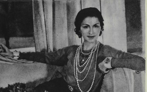 Company founder Coco Chanel wearing her famous string of pearls, October 1956.