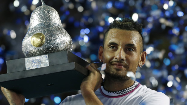 Nick Kyrgios holds up the Mexican Open trophy in Acapulco.