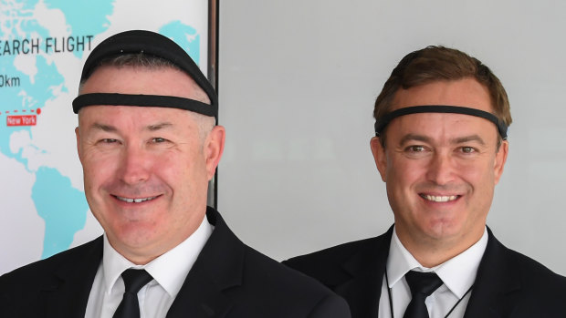 Qantas Captain Sean Golding (left) and first officer Jeremy Sutherland (right) wearing EEG monitoring headbands, which track brain waves to gauge levels of alertness and quality of sleep.   