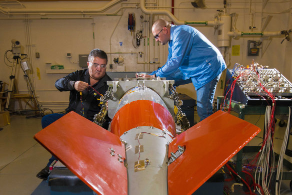 Staff from the National Nuclear Security Administration work on a weapon.