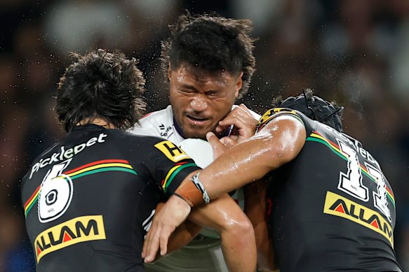 Stefano Utoikamanu is tackled by the Penrith defence.