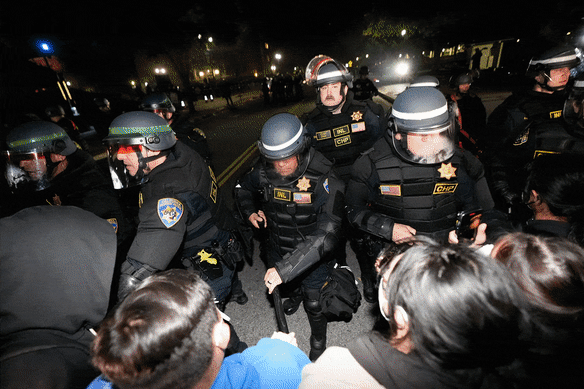 Police advance on pro-Palestinian demonstrators in an encampment on the UCLA campus in Los Angeles.