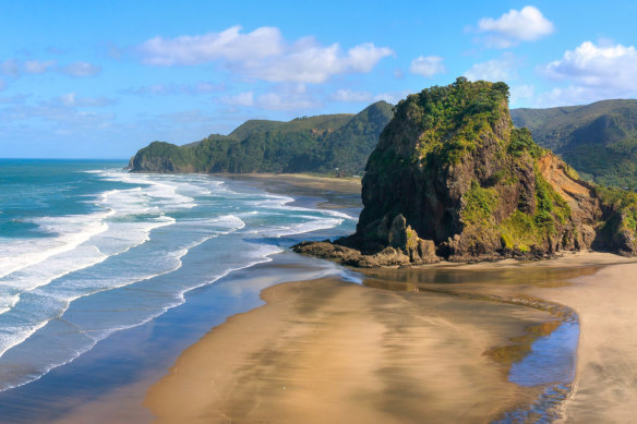 Volcanic Piha Beach is prone to magnificently moody black sands.