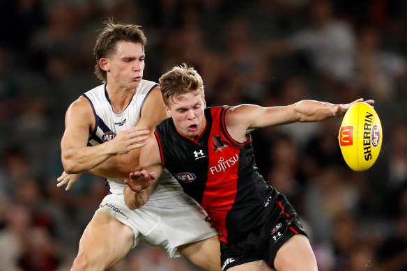 Caleb Serong of the Dockers and Ben Hobbs of the Bombers battle for possession. 