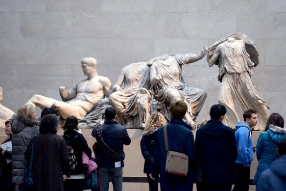 Visitors look at the stolen artefacts, which became known as the Elgin Marbles, in the British Museum.