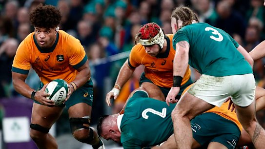 Australia’s Rob Valetini, left, runs with the ball against Ireland