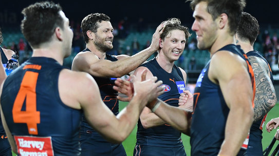 GWS celebrate their nailbiting win against the Swans in Launceston on Saturday.