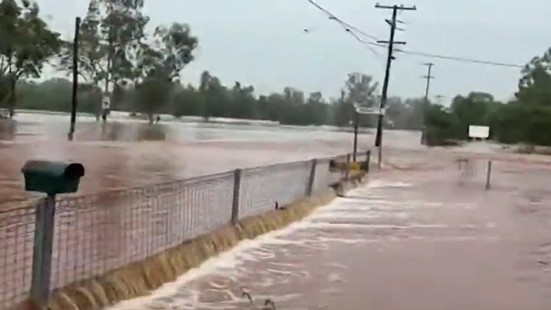 Truckie stuck on roof among dozens rescued in flood, with Brisbane storms possible