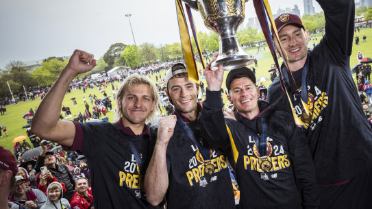 Kai Lohmann Josh Dunkley, Dane Zorko and Harris Andrews hold the cup aloft. 