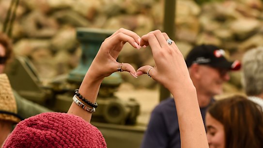People left behind in Mallacoota farewell their loved ones aboard HMAS Choules on Friday.