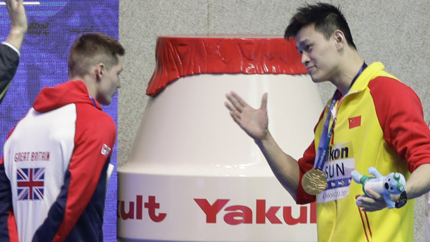 Gold medalist China's Sun Yang confronts  Britain's Duncan Scott after medal ceremony.  