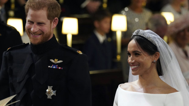 The happy couple: Prince Harry and Meghan Markle grin during the wedding ceremony.
