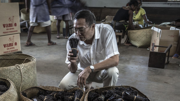 Michel Lomone smells cured vanilla pods at his warehouse in Antalaha.