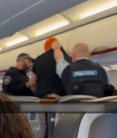 A Jetstar passenger is removed from a flight to the Gold Coast after he was allegedly disruptive before take-off in Sydney in 2023.