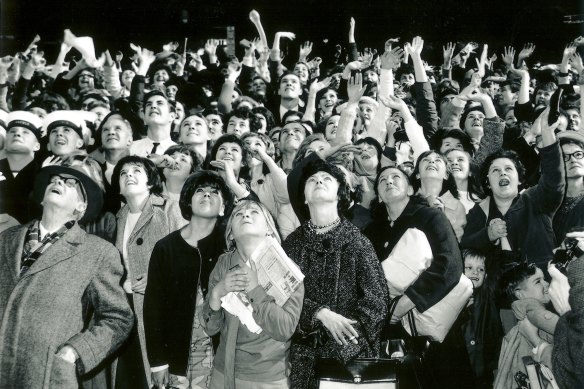 The crowd waits anxiously for the Beatles to appear at the Melbourne Town Hall in 1964.