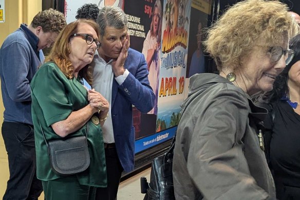 Patrons, including former premier Steve Bracks, head out of the venue after the opening night’s sudden cancellation.