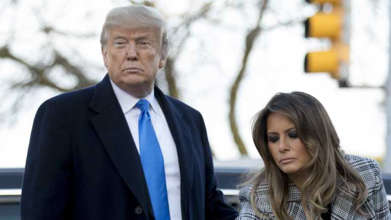First lady Melania Trump, accompanied by President Donald Trump, puts down a white flower at a memorial for those killed at the Tree of Life Synagogue in Pittsburgh.