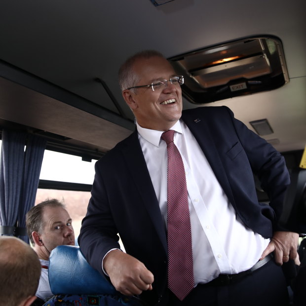 Scott Morrison hitches a ride on the media bus while campaigning in northern Tasmania.
