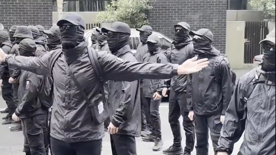 Neo-Nazis dressed in black at the refugee protest in Docklands on Tuesday.