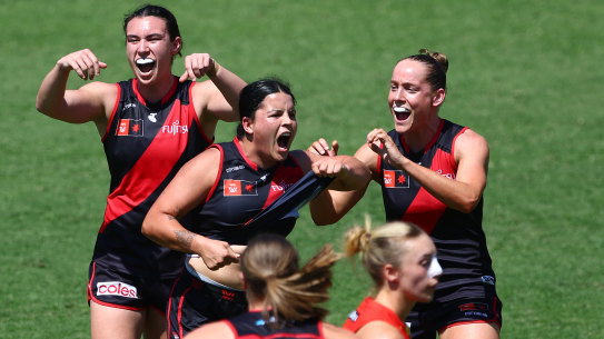 Taking a stand: Essendon star Maddy Prespakis points to her stomach in a show of pride after booting a goal on Sunday.