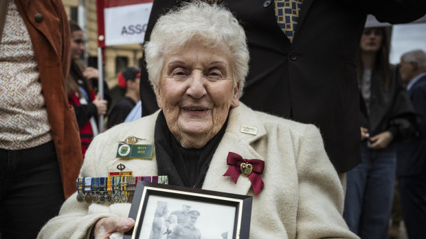 Betty Quee, 87, held a picture of her husband Brian Quee as she joined her first-ever Anzac Day procession in Melbourne.