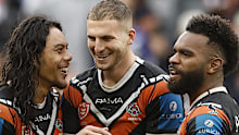 SYDNEY, AUSTRALIA - AUGUST 03: Jarome Luai, Adam Doueihi and Sunia Turuva of the Wests Tigers celebrate victory during the round 22 NRL match between Wests Tigers and Canterbury Bulldogs at CommBank Stadium, on August 03, 2025, in Sydney, Australia. (Photo by Mark Evans/Getty Images)