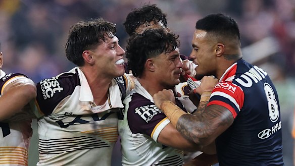 Spencer Leniu (right) of the Roosters exchanges heated words with Kotoni Staggs of the Broncos in Las Vegas.