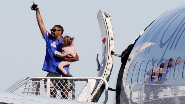 Liam Ryan, with his daughter in his arms, waved farewell when West Coast players and staff flew to the Gold Coast for the resumption of the AFL season.