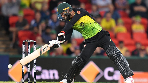 Heave ho: Glenn Maxwell reaches for a shot in the reduced contest.