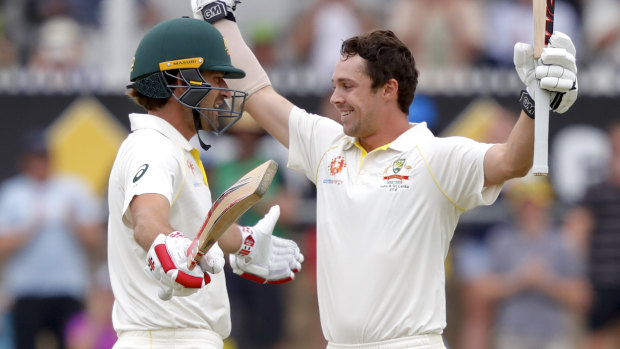Australia's Travis Head (right) celebrates with teammate Joe Burns after reaching his century.